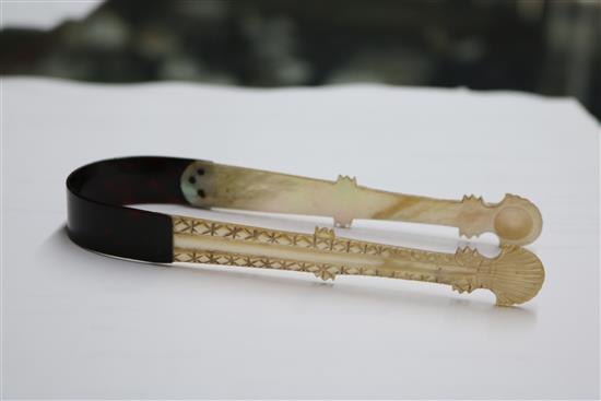 A pair of George III mother of pearl and tortoiseshell sugar tongs